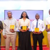 photo of mindset and attitude foundation team with inooro tv hosts holding the AFMES book written by founder Eric Otieno