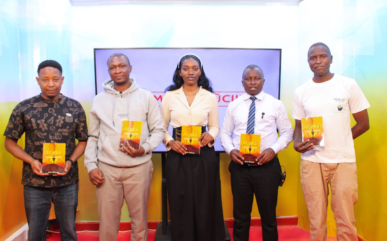 photo of mindset and attitude foundation team with inooro tv hosts holding the AFMES book written by founder Eric Otieno